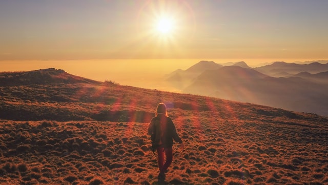 picture of a person with a sunset in the background